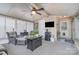 A relaxing sunroom features wicker furniture, a ceiling fan, and a mini refrigerator for comfortable leisure at 113 Marina Ln, Mooresville, NC 28117