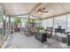 A sunroom filled with wicker furniture, leafy plants, and lots of light, provides a peaceful indoor retreat at 113 Marina Ln, Mooresville, NC 28117
