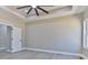 Spacious bedroom with tray ceiling, ceiling fan, and natural light creating a serene and comfortable retreat at 115 Falling Creek Dr, Statesville, NC 28625