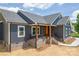 This gorgeous house has navy blue siding, black roof and white trim at 115 Falling Creek Dr, Statesville, NC 28625