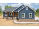 Beautiful, new construction home featuring navy blue siding and a brick foundation at 115 Falling Creek Dr, Statesville, NC 28625
