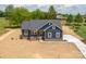 Charming home featuring dark siding, a welcoming porch, and a long driveway, surrounded by lush trees at 115 Falling Creek Dr, Statesville, NC 28625