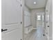 Hallway with mudroom-style bench, overhead storage, and hall closet at 115 Falling Creek Dr, Statesville, NC 28625