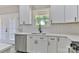 Clean white kitchen features quartz countertops, modern subway tile backsplash and stainless steel dishwasher, making it move-in ready at 115 Falling Creek Dr, Statesville, NC 28625