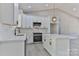 Modern kitchen showcases white cabinetry, stainless steel appliances, and an island with pendant lighting, ready for culinary adventures at 115 Falling Creek Dr, Statesville, NC 28625