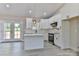 Bright kitchen features white cabinets, stainless steel appliances, and a functional center island, perfect for cooking at 115 Falling Creek Dr, Statesville, NC 28625