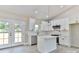 Modern kitchen features an island, stainless steel appliances and subway tile backsplash at 115 Falling Creek Dr, Statesville, NC 28625