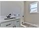 Laundry room area with sink and storage at 115 Falling Creek Dr, Statesville, NC 28625