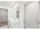 Modern bathroom featuring a dual sink vanity, large mirror, and access to a spacious walk-in closet at 125 Canoga Ave, York, SC 29745