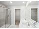 Stylish bathroom featuring a dual sink vanity, glass enclosed shower, and access to a walk-in closet at 125 Canoga Ave, York, SC 29745
