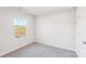 Clean and bright bedroom with neutral carpeting and a view of the neighborhood at 125 Canoga Ave, York, SC 29745