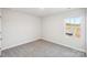 Bright, carpeted bedroom with a large window overlooking the neighborhood at 125 Canoga Ave, York, SC 29745