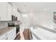 Bright kitchen with white cabinets, stainless steel appliances, granite countertops, and mosaic backsplash at 125 Canoga Ave, York, SC 29745