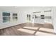 Light-filled living area with wood floors, a large window, and an open view to the modern kitchen at 125 Canoga Ave, York, SC 29745