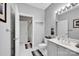 Clean bathroom featuring a vanity with a sink, toilet, and a doorway with a view of the tub at 127 N Tryon St # 404, Charlotte, NC 28202