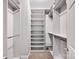 Well-organized walk-in closet with ample shelving and storage space, designed for effortless organization and convenience at 127 N Tryon St # 404, Charlotte, NC 28202