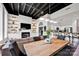 An inviting open-concept living space with a fireplace, modern kitchen, and sleek lighting, ideal for entertaining at 127 N Tryon St # 404, Charlotte, NC 28202