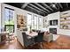 An open living area with hardwood floors, a modern fireplace, and large windows offering urban views and natural light at 127 N Tryon St # 404, Charlotte, NC 28202