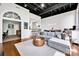 Open-concept living room with modern decor, hardwood floors, city view windows, and a comfortable sectional sofa at 127 N Tryon St # 404, Charlotte, NC 28202