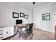 Home office with natural light, modern furniture, framed degrees, and carpeted floors at 127 N Tryon St # 404, Charlotte, NC 28202