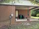 The back porch is made of concrete and is covered by an awning. There are trash bins at 13134 Homewood Dr, Charlotte, NC 28262
