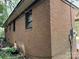 Side exterior of brick home, shows the wall and electrical panel at 13134 Homewood Dr, Charlotte, NC 28262