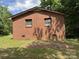 Side view of a brick house, with simple lines and shaded yard at 13134 Homewood Dr, Charlotte, NC 28262