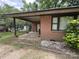 Brick house with a back porch and small rock bed for the garden at 13134 Homewood Dr, Charlotte, NC 28262