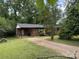 Expansive backyard with lush greenery and a single-story brick home, perfect for outdoor living at 13134 Homewood Dr, Charlotte, NC 28262