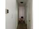Hallway leading to rooms, displaying carpet and access to storage at 13134 Homewood Dr, Charlotte, NC 28262