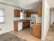 A full kitchen featuring wooden cabinets, appliances, and a window above the sink at 13134 Homewood Dr, Charlotte, NC 28262