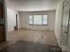 A large living room with a window, door, and vinyl flooring at 13134 Homewood Dr, Charlotte, NC 28262
