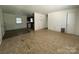 Open-concept living room featuring view of the kitchen and a separate door at 13134 Homewood Dr, Charlotte, NC 28262