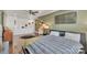 Upstairs bedroom featuring wood floors, ceiling fan, and stairs to the loft at 1328 Somersby Cir, Gastonia, NC 28054
