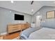 This bedroom features a large TV, vaulted ceiling, and ample storage space with wooden dressers at 1328 Somersby Cir, Gastonia, NC 28054