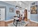 Open dining room with modern light fixture, hardwood floors, and view of the kitchen bar area at 1328 Somersby Cir, Gastonia, NC 28054