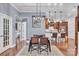 Modern dining room with hardwood floors and views of the kitchen featuring bar seating and stainless steel appliances at 1328 Somersby Cir, Gastonia, NC 28054