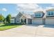 Inviting home exterior featuring a well-kept lawn, stone accents, and an attached two-car garage at 1328 Somersby Cir, Gastonia, NC 28054