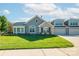 Charming home with stone accents, lush lawn, and a two-car garage on a sunny day at 1328 Somersby Cir, Gastonia, NC 28054