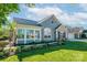 Attractive gray home with a well-manicured lawn and flowering plants, creating inviting curb appeal at 1328 Somersby Cir, Gastonia, NC 28054