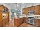 Well-lit kitchen with wooden cabinets, stainless steel appliances, and an open design at 1328 Somersby Cir, Gastonia, NC 28054
