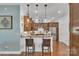 Stylish kitchen with stainless steel appliances, a breakfast bar with stools, and rich wooden cabinetry at 1328 Somersby Cir, Gastonia, NC 28054