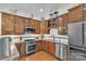 Well-lit kitchen featuring stainless steel appliances, wood cabinets and stone countertops at 1328 Somersby Cir, Gastonia, NC 28054