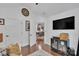 Open living space featuring hardwood floors, a large television, and access to the dining room through an open doorway at 1328 Somersby Cir, Gastonia, NC 28054