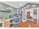 Home office featuring vaulted ceiling, modern desk, and view of the dining room through open french doors at 1328 Somersby Cir, Gastonia, NC 28054