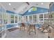 Bright sunroom featuring tile floors, ample windows with shutters, and vaulted ceiling offering a cozy and airy space at 1328 Somersby Cir, Gastonia, NC 28054