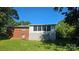 Expansive backyard features a lush lawn and the home with an attached sunroom at 133 Pine State Rd, Troutman, NC 28166