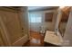Functional bathroom with tub and sink combo, wood floor, and natural lighting at 133 Pine State Rd, Troutman, NC 28166