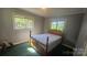 Cozy bedroom features vintage wood bed frame, two windows, and great natural light at 133 Pine State Rd, Troutman, NC 28166
