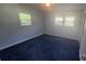 Clean bedroom with blue carpet features ample light with two bright windows at 133 Pine State Rd, Troutman, NC 28166
